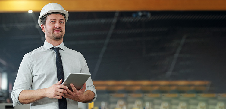 A engineer holding a clipboard at work