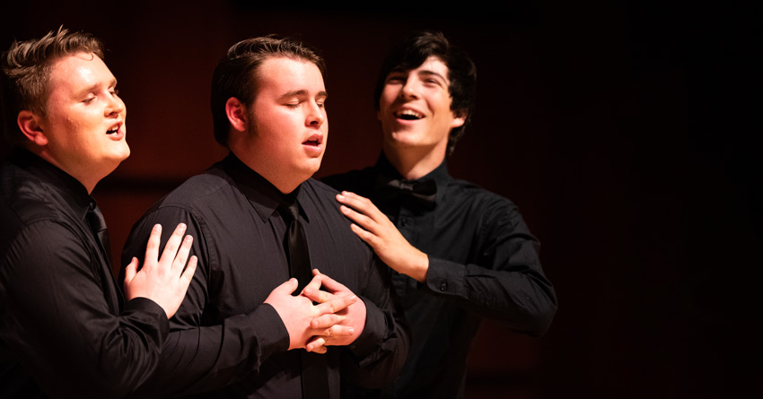 Students performing in a musical on campus