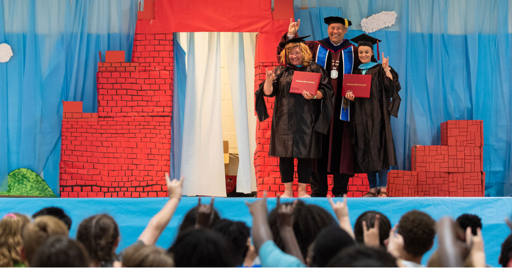 Damphousse Delivers Diplomas,&nbsp;while Commencement Draws Siblings Together