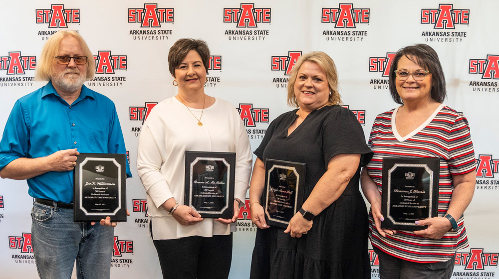 Photo of four people with 30 years of service