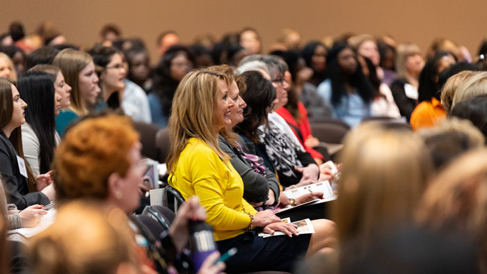 Women sit and listen to speaker at 2022 WLC