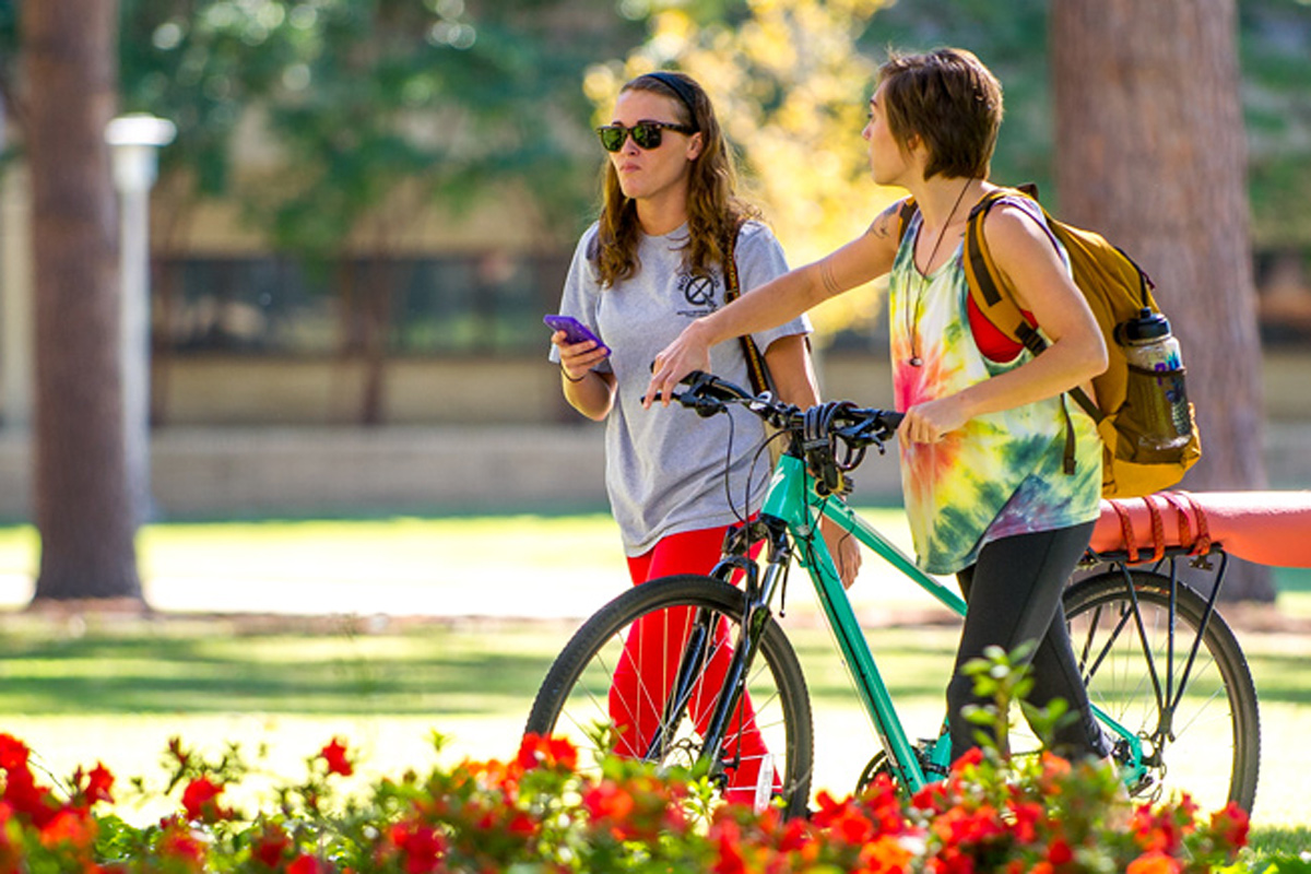 Two girls walking on campus.